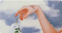 a woman's hand with a flower on it